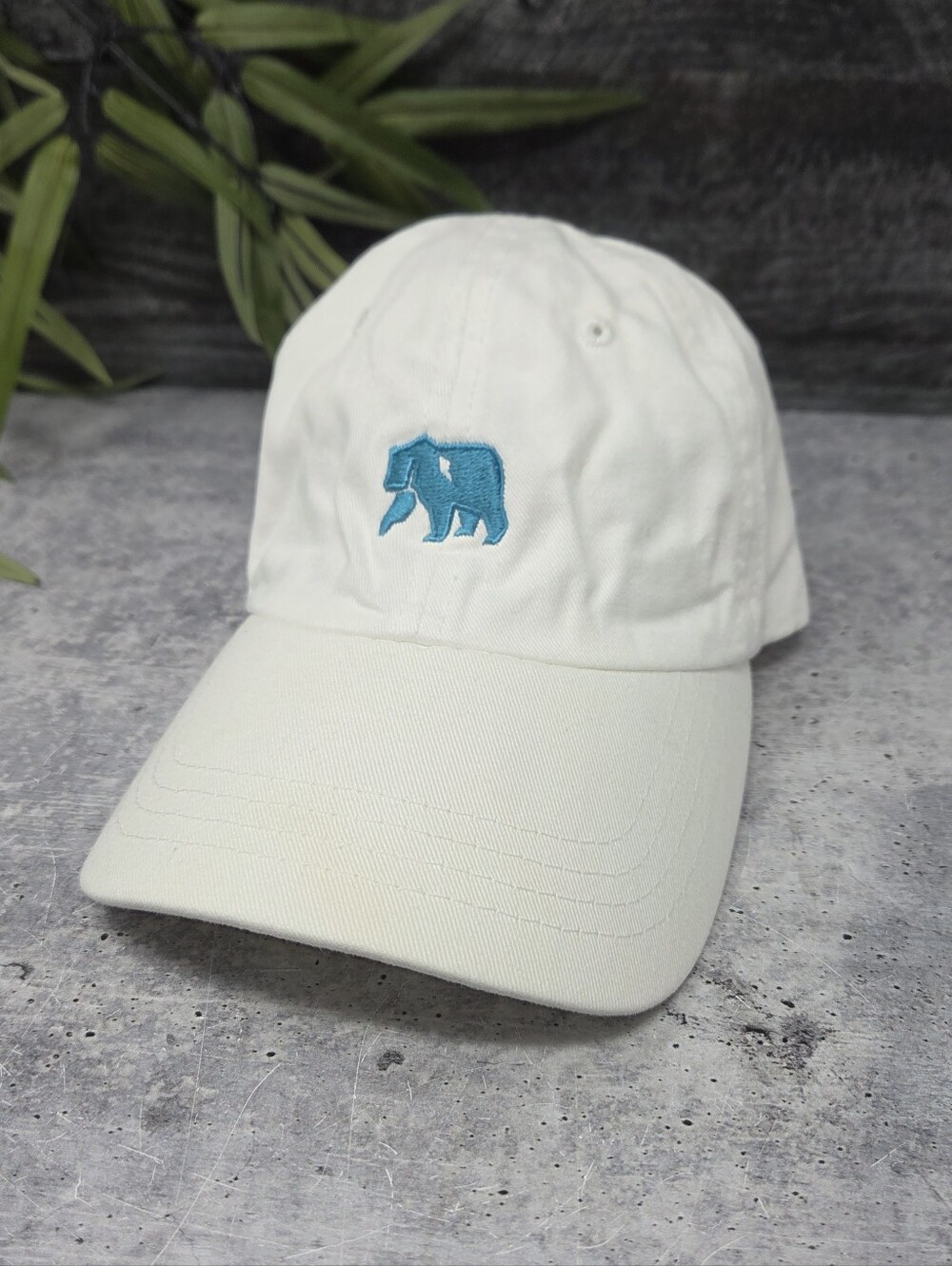 The Normal Brand White Dad Cap with Teal Blue Bear Logo Adjustable Back Cotton